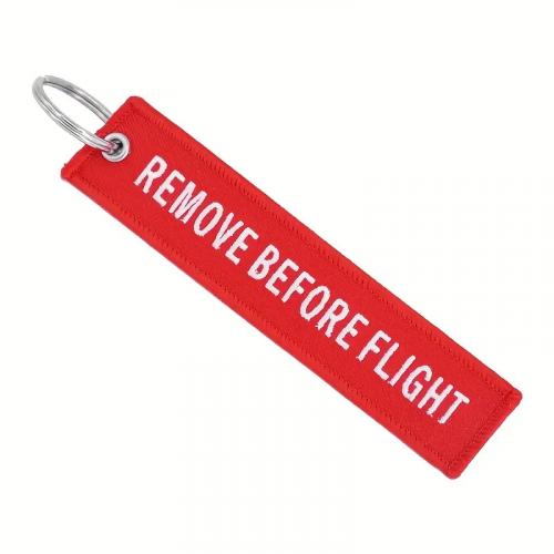 Přívěsek na klíče Bist Remove before flight - červený