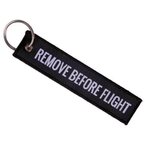 Přívěsek na klíče Bist Remove before flight - černý